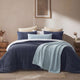 Sunday Citizen Snug Lumbar Pillow and Throw in Misty Blue on a bed
